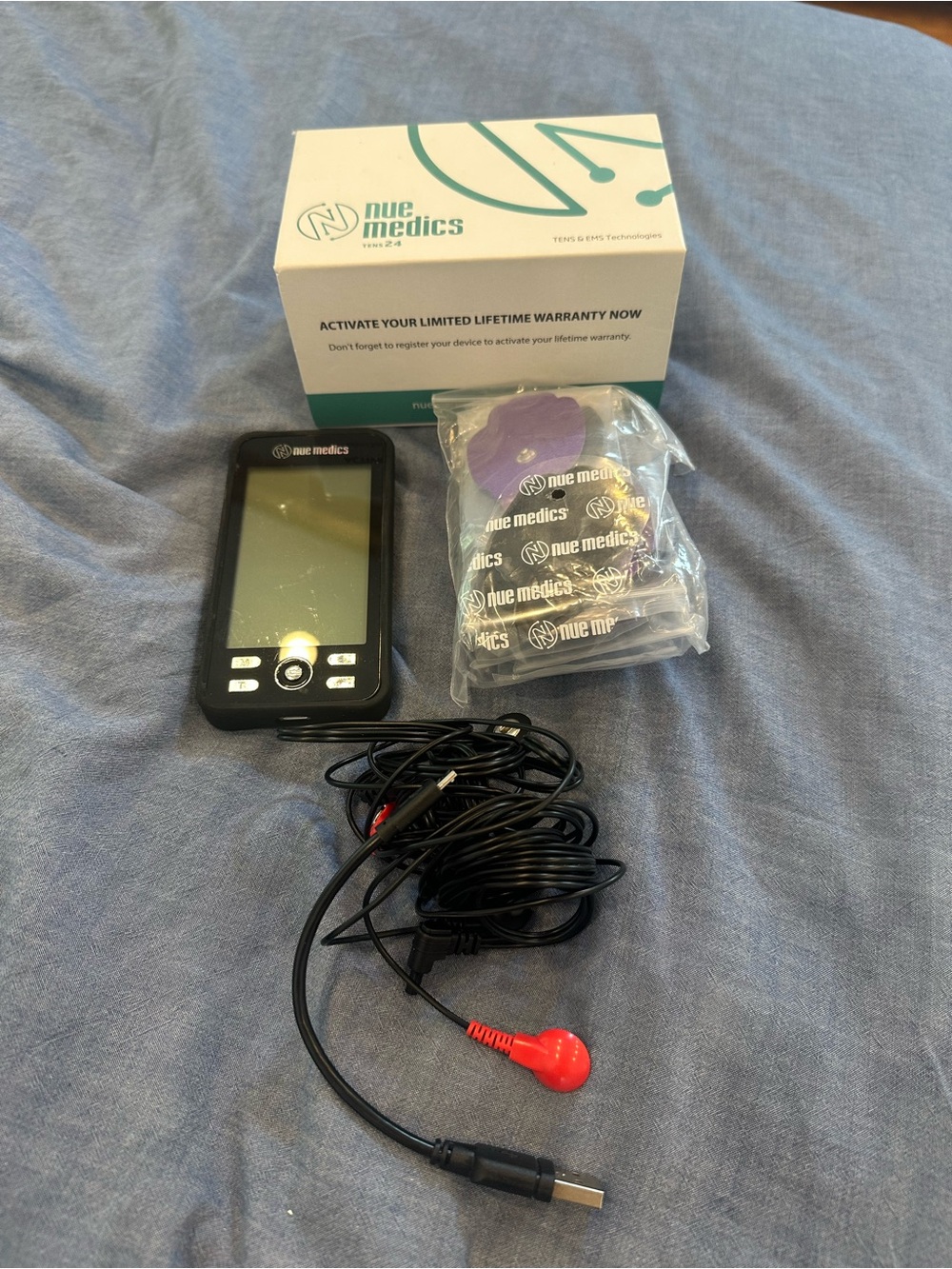 Nue Medics TENS Unit in Black with Purple Pads